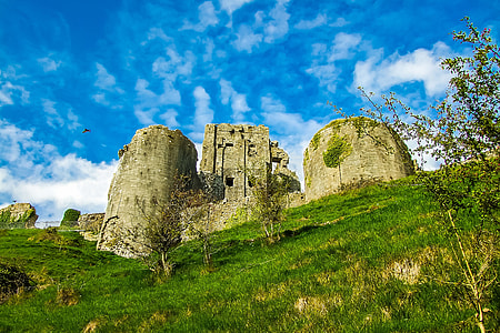 old white concrete castle surrounded by grass photo during daytime thumbnail