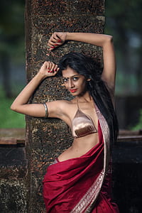 woman in bronze-colored brassiere and red sari dress thumbnail