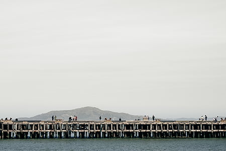 people on pier during daytime thumbnail