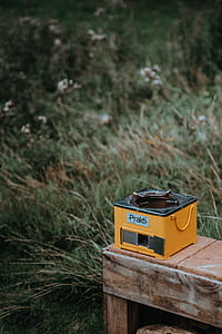 selective focus photography of yellow burner stove on brown panel thumbnail