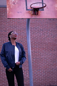 Woman Standing Near Basketball Hoop thumbnail