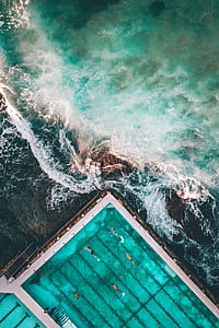 concrete pool near body of water thumbnail