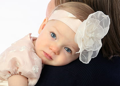 closeup photography of woman carrying baby thumbnail