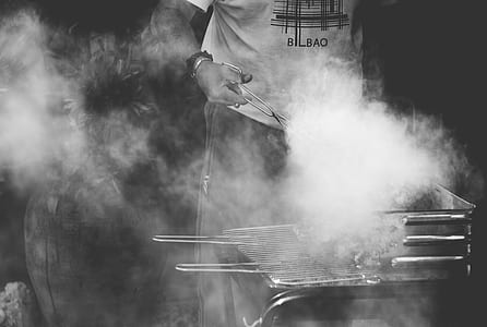 grayscale photo of person grilling meat photo thumbnail