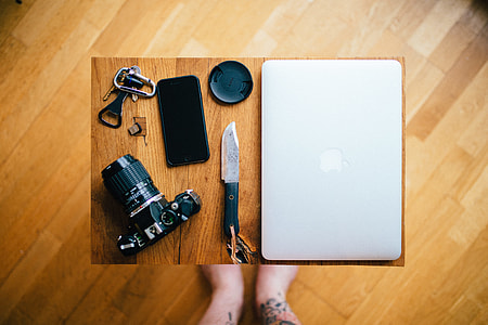 flat lay photography of black DSLR camera, black smartphone, and black knife thumbnail