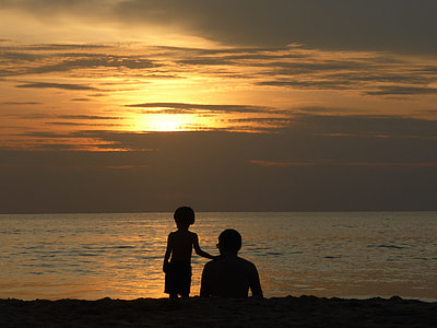 silhouette of man and boy near seashore during golden hour thumbnail
