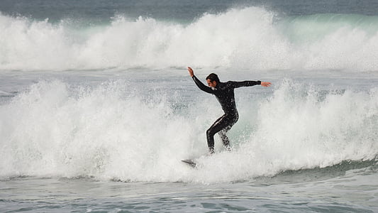 man surfing during daytime thumbnail