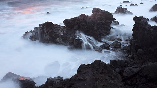 body of water near rock formation thumbnail