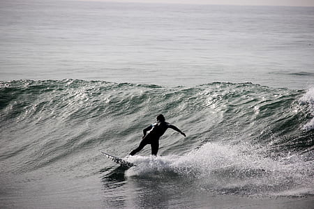 man surfing during daytime thumbnail