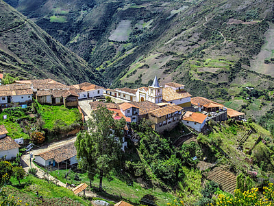 white and beige village on hill thumbnail