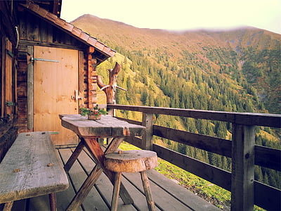 brown wooden table on terrace near forest mountain thumbnail