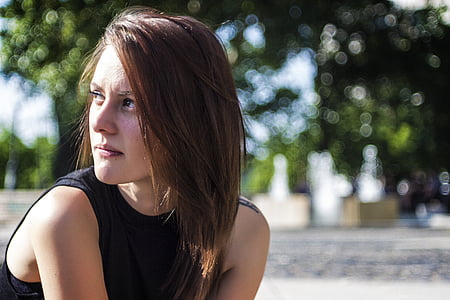woman looking on her right side at the park thumbnail