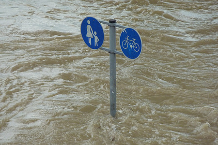blue and gray road sign post covered with water thumbnail