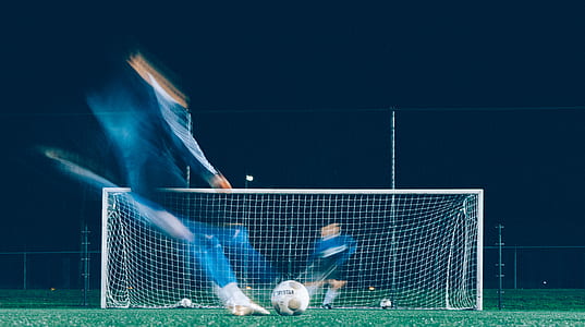 two man playing soccer during nighttime thumbnail