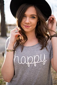 woman wears gray Happy scoop-neck shirt and black fedora hat thumbnail