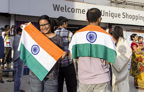 woman smiling while holding flag of India at daytime thumbnail