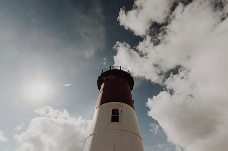 low angle of white and red painted lighthouse thumbnail