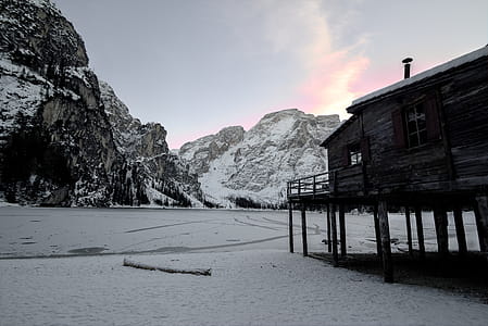 Wooden House Near Mountain Covered With Snow thumbnail