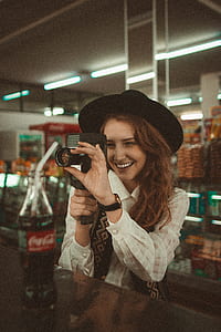 woman holding 8 mm camcorder thumbnail