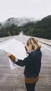 woman reading newspaper at the road thumbnail
