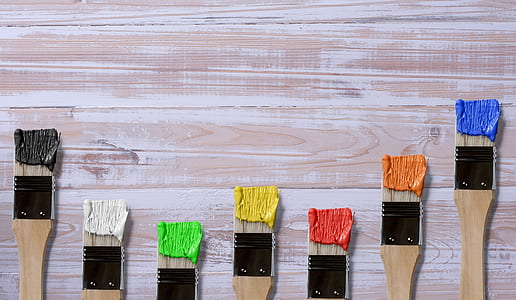 seven brown-and-black paint brushes with assorted-color paints thumbnail