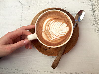 white ceramic teacup on brown wooden plate thumbnail