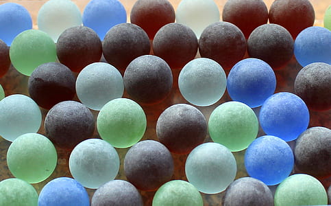 scattered assorted-color balls on brown slab thumbnail