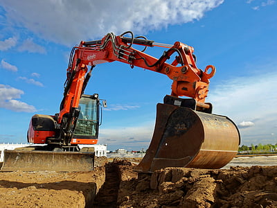 red backhoe on brown soil thumbnail