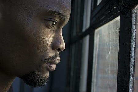 man staring out a window thumbnail
