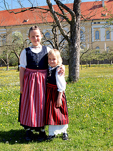 girl holding toddler outdoors thumbnail