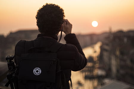 man taking photo of sunset thumbnail