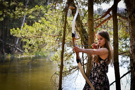 woman holding brown composite bow thumbnail