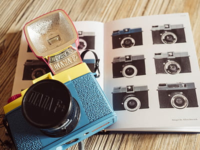 blue and yellow flash camera on opened book thumbnail