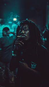 man holding spliff at nighttime thumbnail