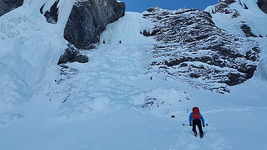 person climbing snow-covered mountain thumbnail