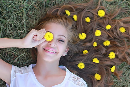 woman holding yellow mums flower in her eye thumbnail