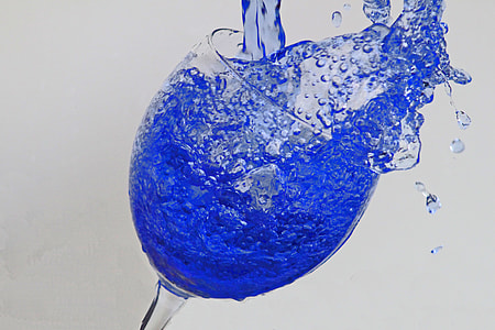 clear wine glass with blue liquid thumbnail
