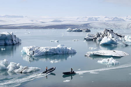 two black inflatable boats near glacier thumbnail