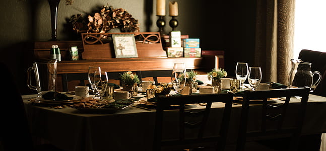 clear footed glass on brown dining table thumbnail