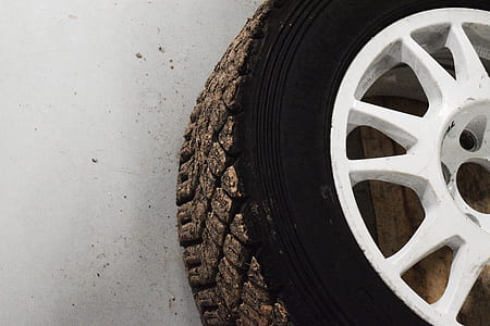 white multi-spoke vehicle wheel and tire on floor thumbnail