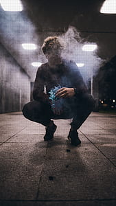 man sitting on gray concrete pavement thumbnail