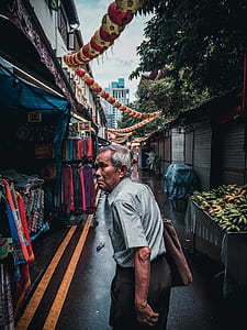 man walking on hallway beside clothing store thumbnail