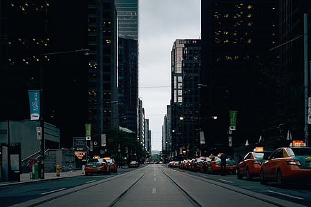 cars on road between buildings thumbnail