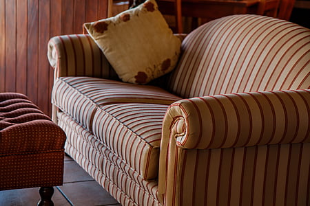 white and brown striped couch and white throw pillow on top thumbnail