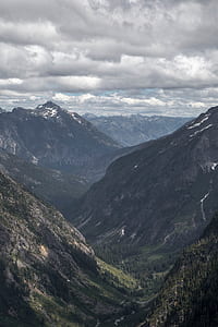 green trees in mountain under white clouds thumbnail
