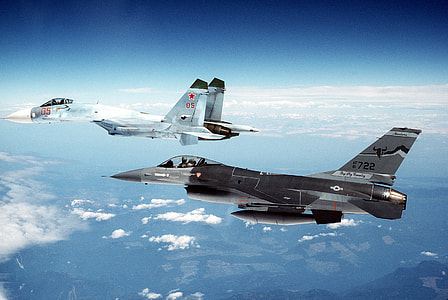 two gray and black fighter planes in flight thumbnail