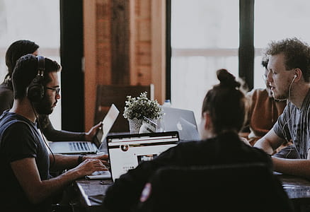 people sitting beside table near clear glass windows thumbnail