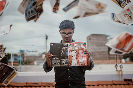 man reading Better Photography book thumbnail