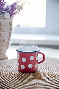 Red, White, and Black Ceramic Mug on Table thumbnail