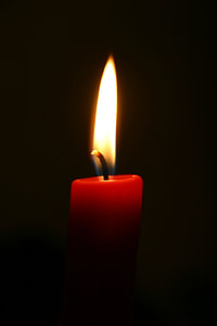 lighted red candle with black background thumbnail